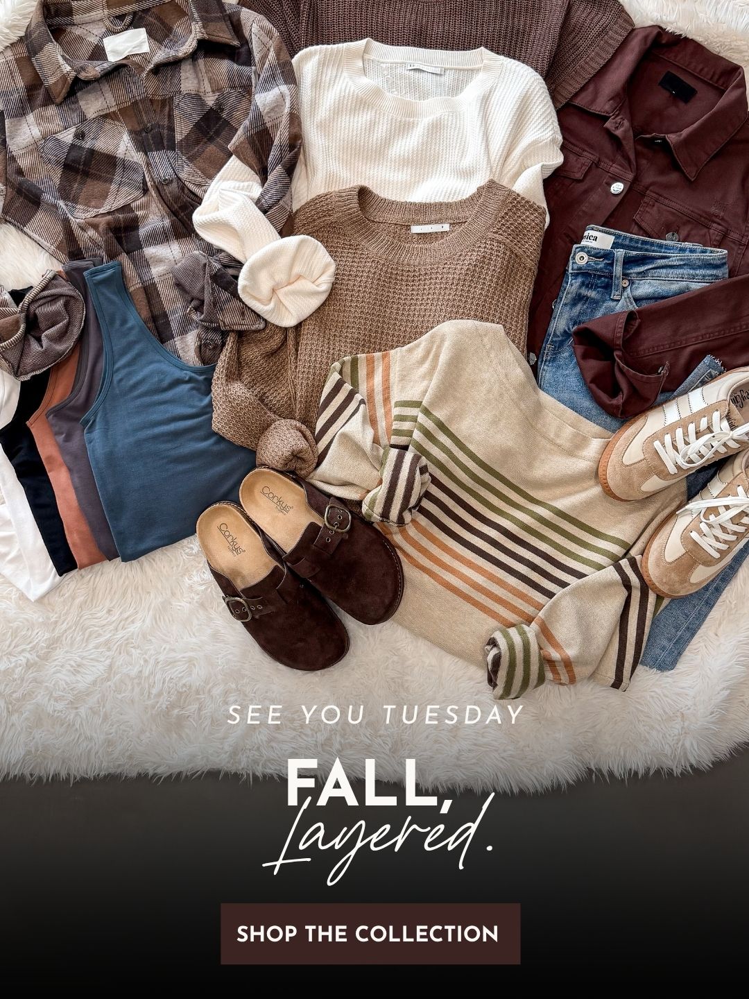 A styled flat lay of fall clothing on a white faux-fur surface, including a plaid flannel shirt, cream ribbed top, brown knit sweater, burgundy button-up, blue jeans, striped knit, brown mule shoes, and beige sneakers. Text at the bottom reads 'SEE YOU TUESDAY FALL, Layered.