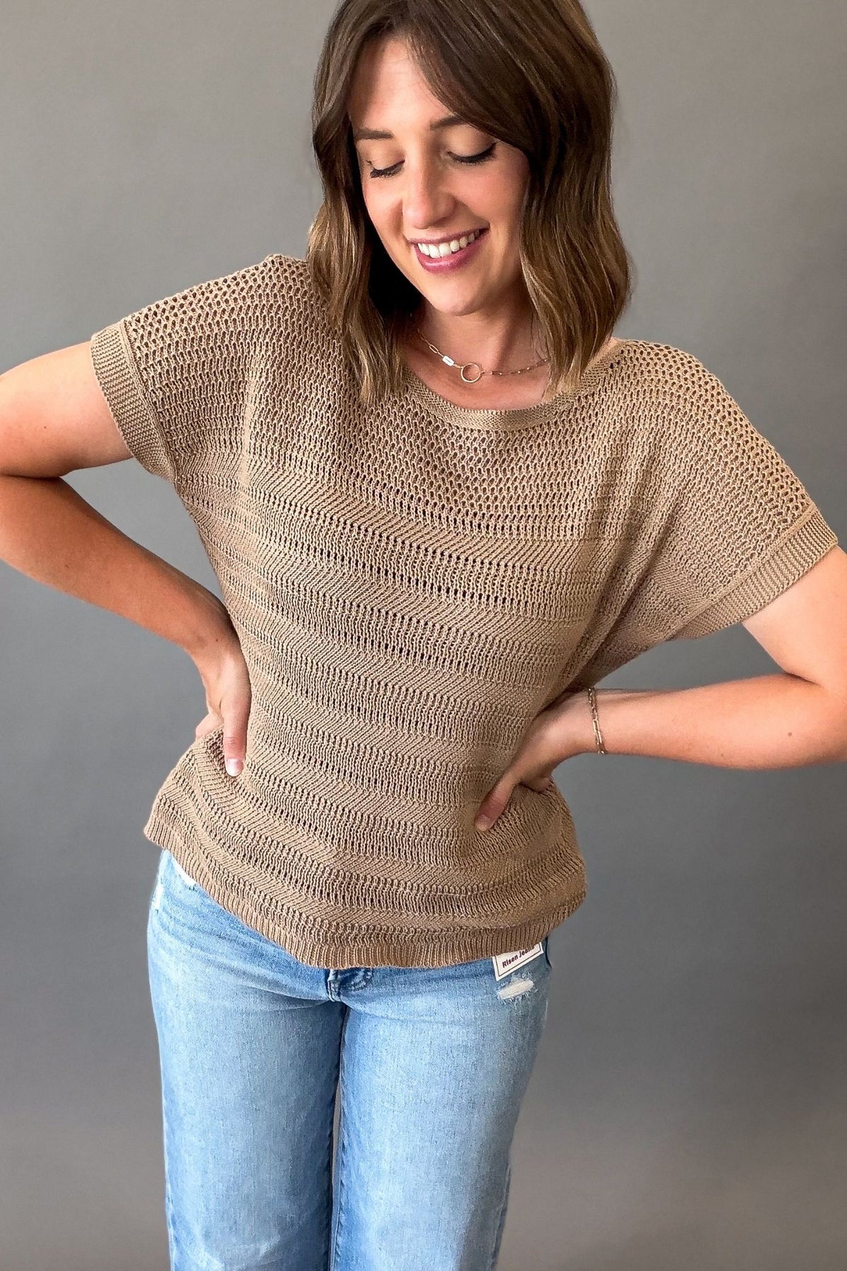 woman wearing a mocha crew neck short sleeve pointelle sweater