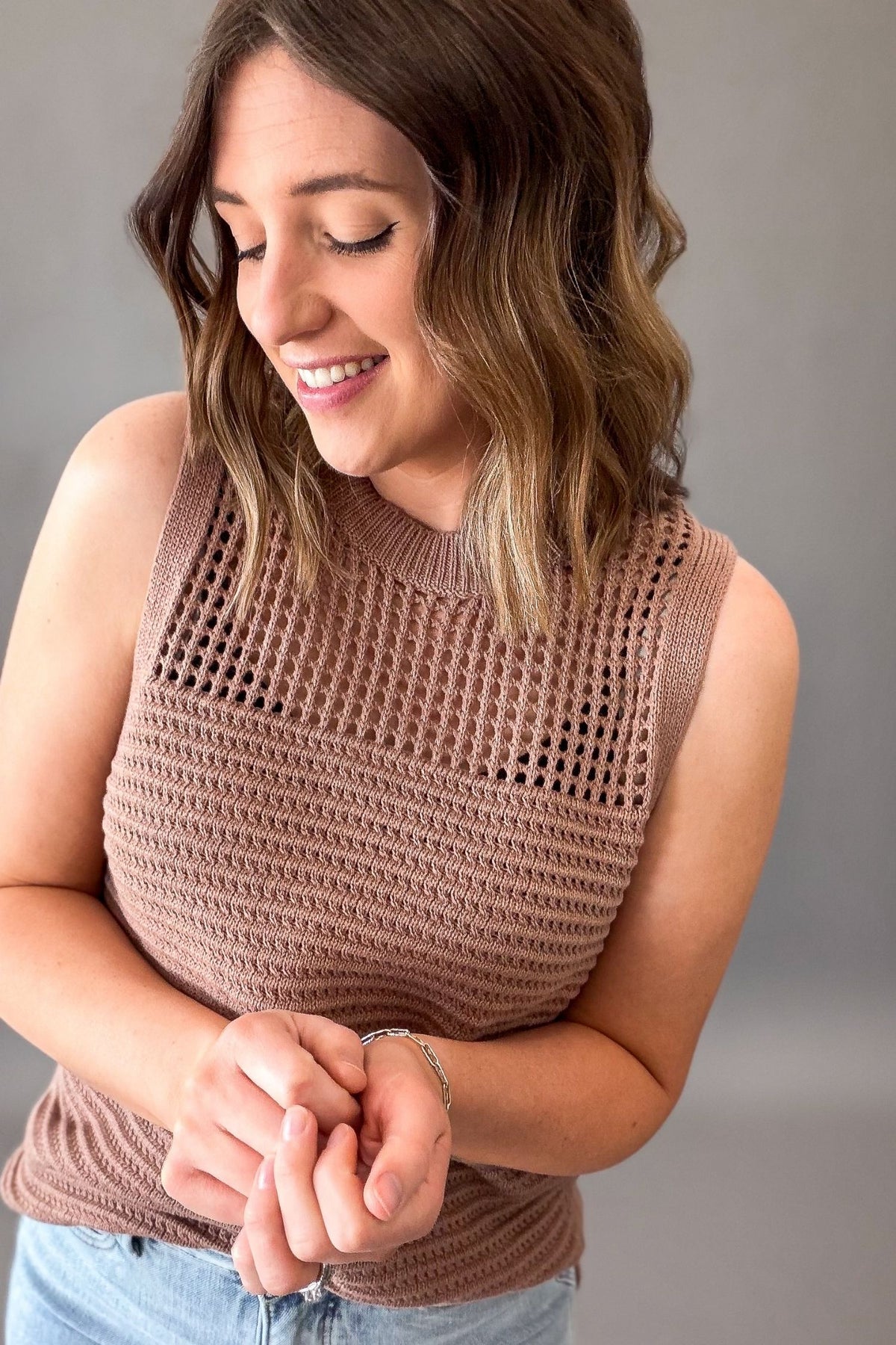woman wearing a Mocha fish net pointelle sleeveless sweater