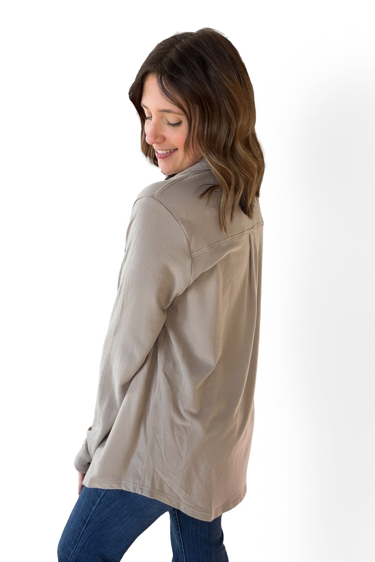 Woman wearing a beige jacket on a white background