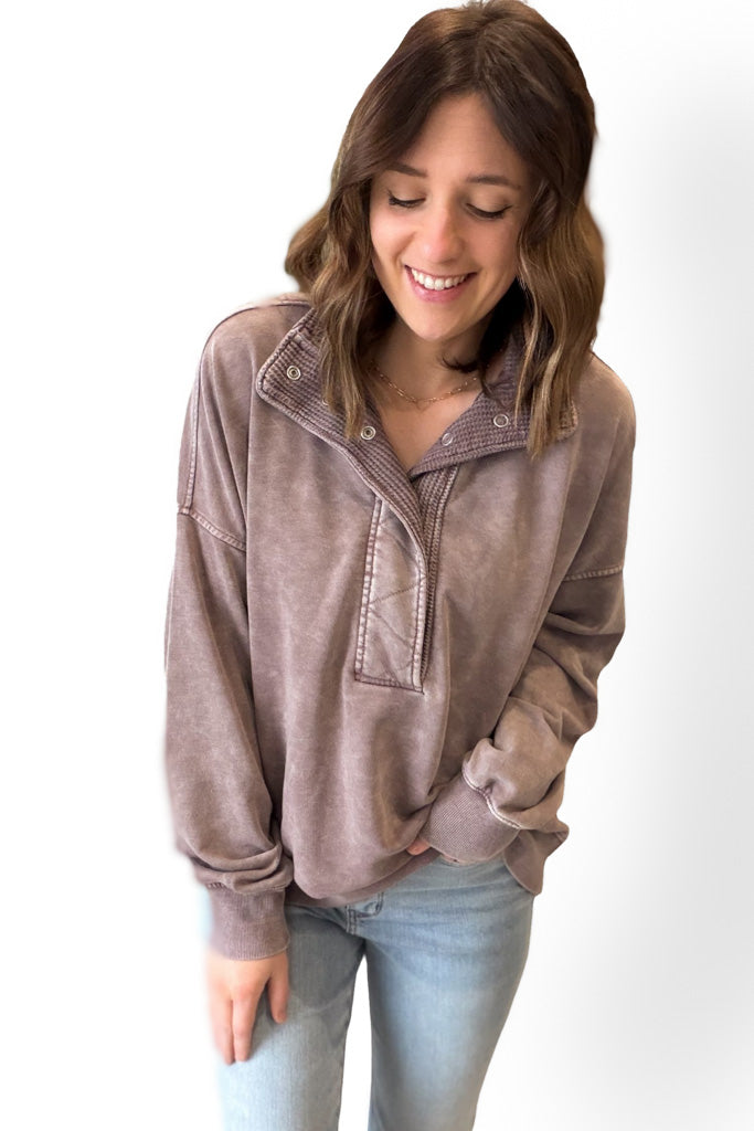Woman wearing a mocha pullover with a white background