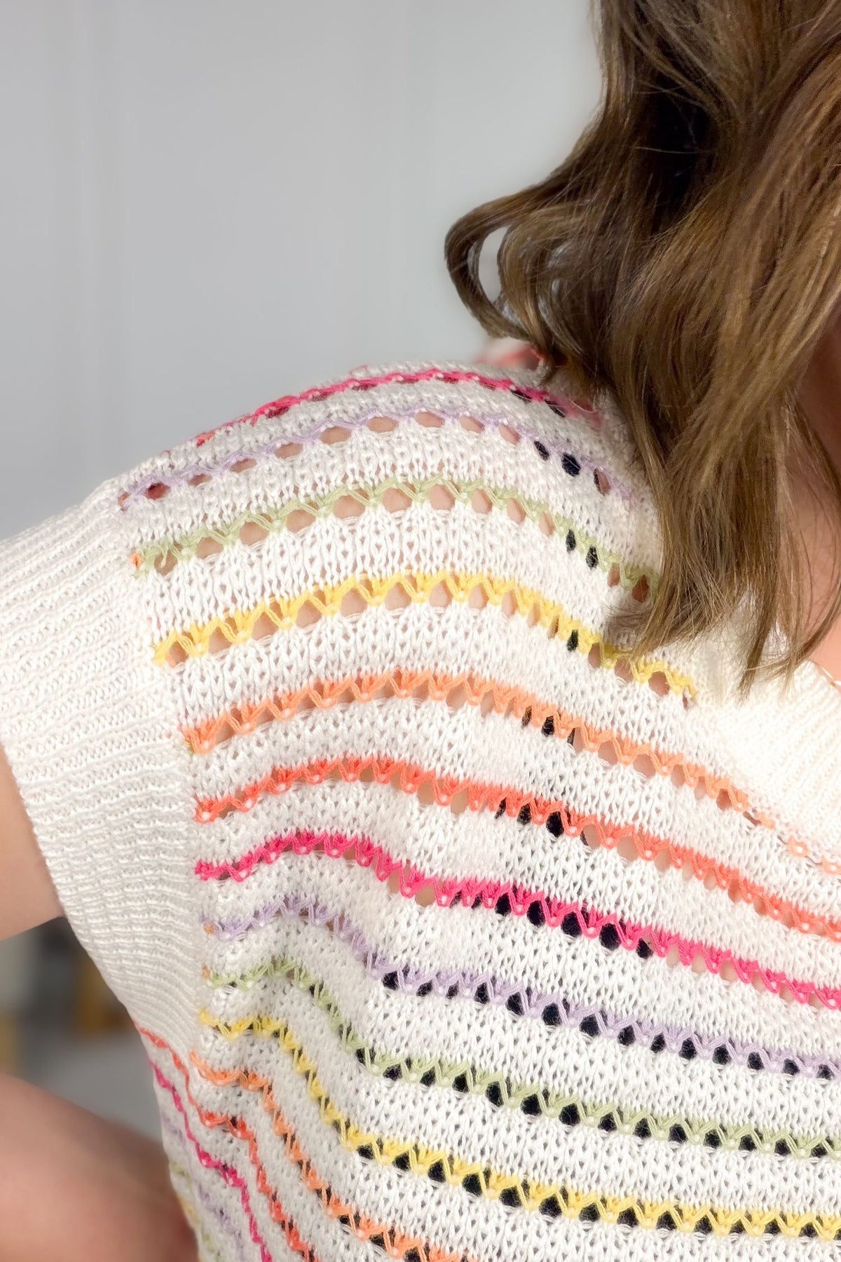 Lightweight sheer sweater layered with tank top showing a close up detail