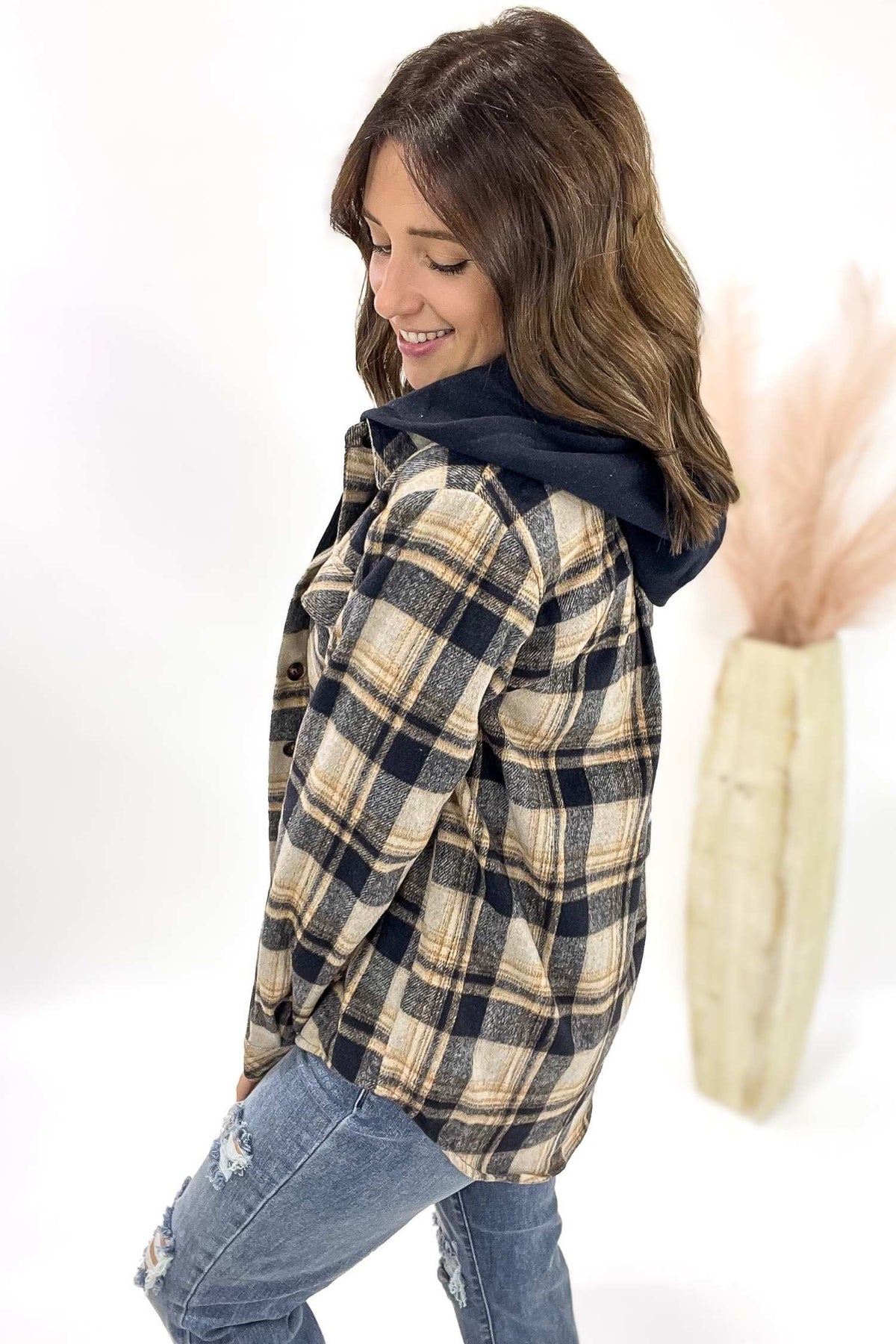 Woman wearing a plaid shirt with a white background
