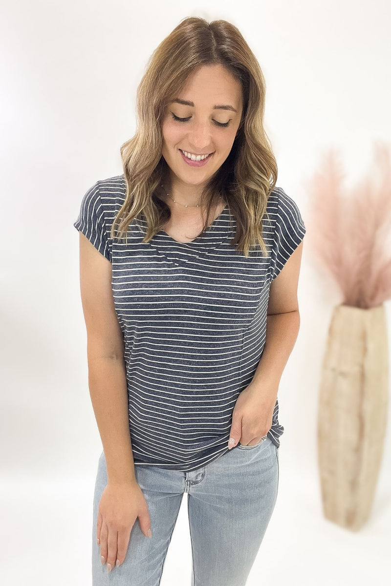 Woman wearing a striped shirt and jeans on a white background