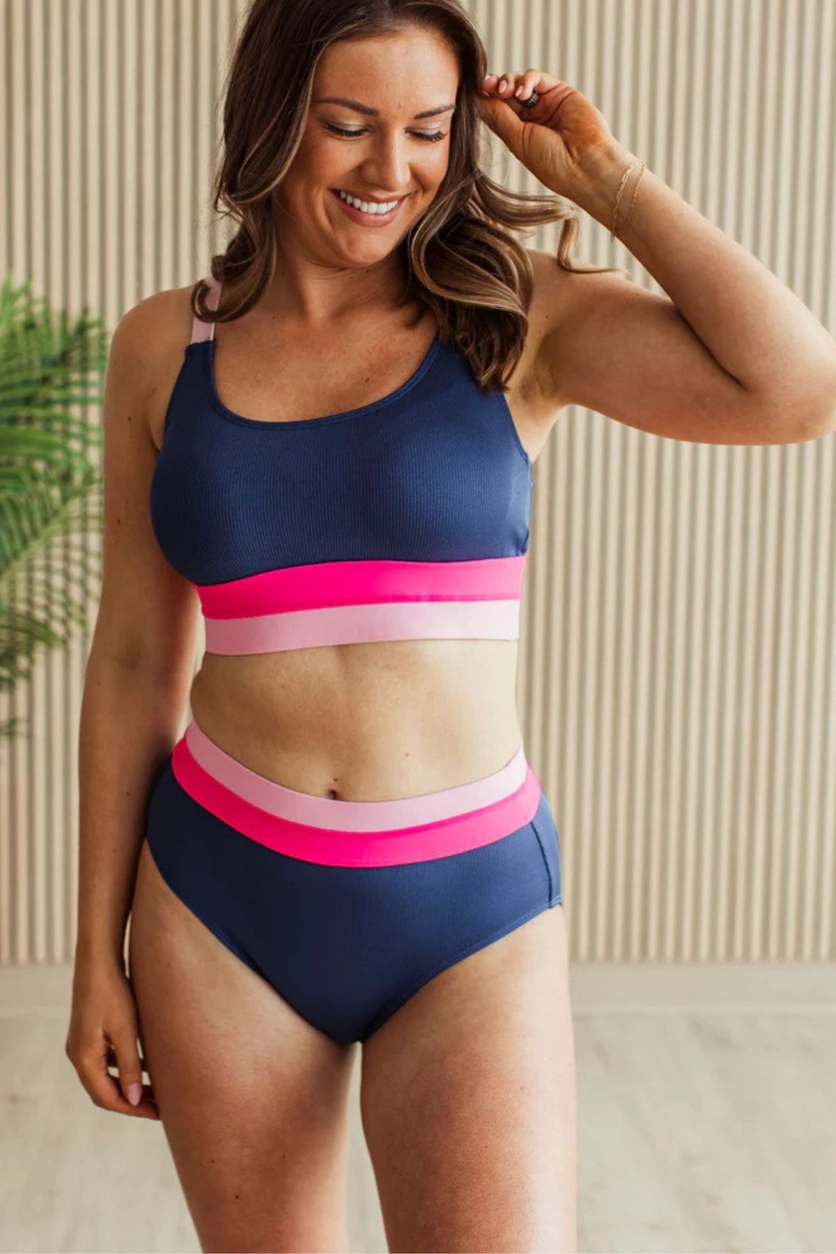 Navy ribbed high rise swim bottoms with pink and blush waistband detail.
