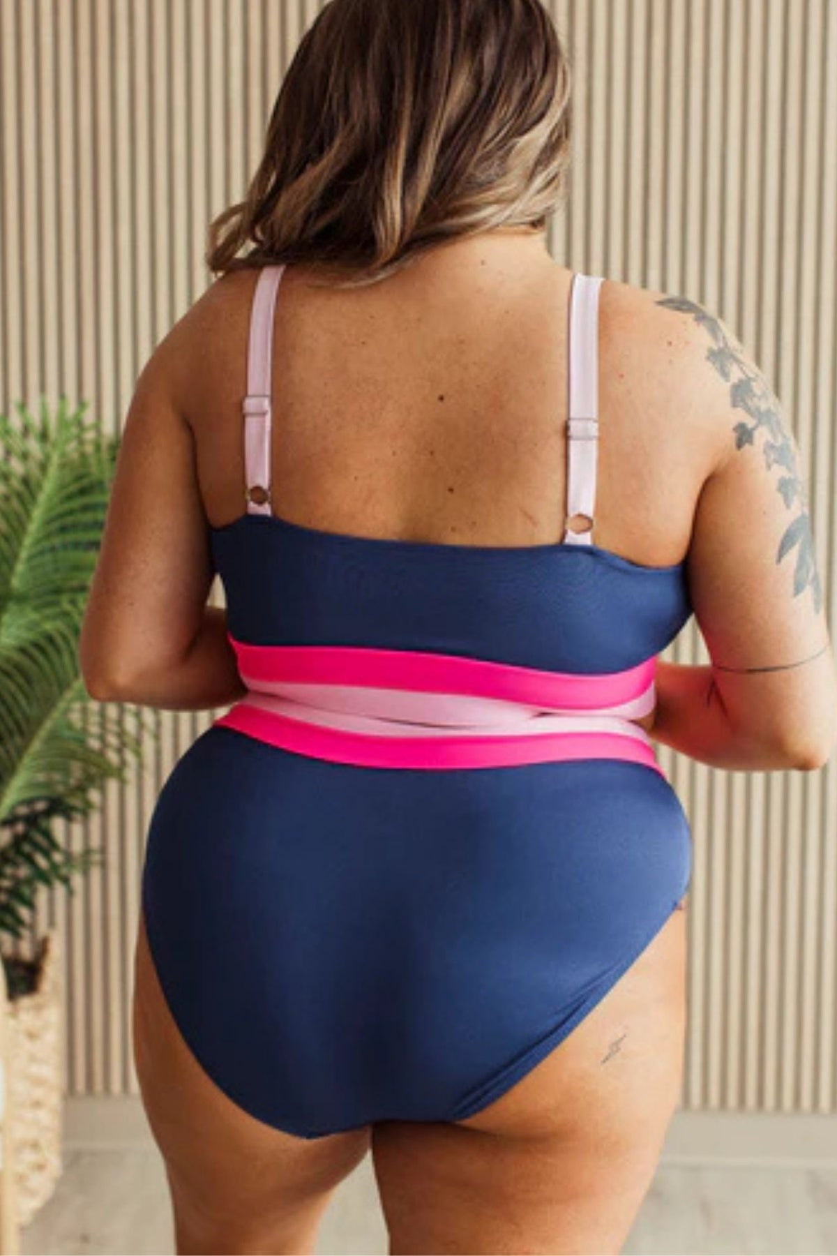 Navy ribbed high rise swim bottoms with pink and blush waistband detail. showing back details