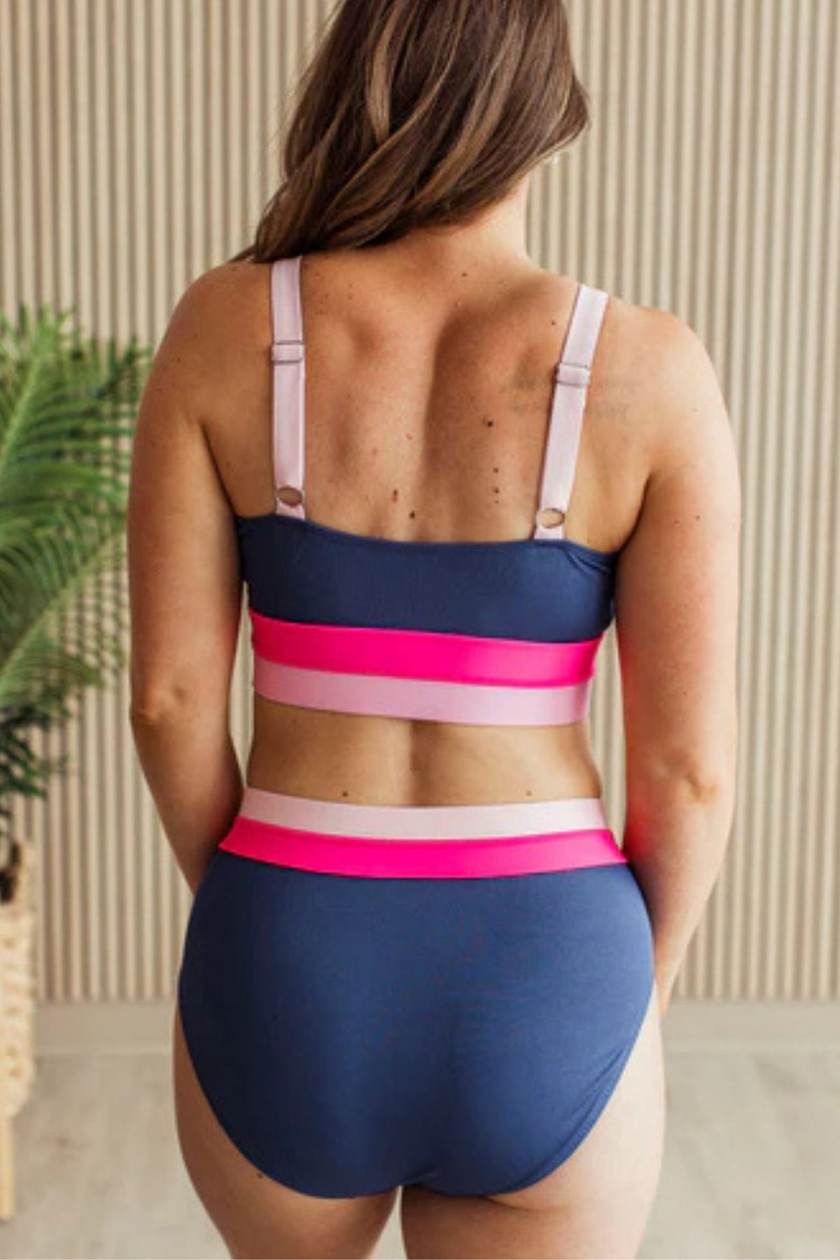 Navy ribbed high rise swim bottoms with pink and blush waistband detail. showing back coverage details