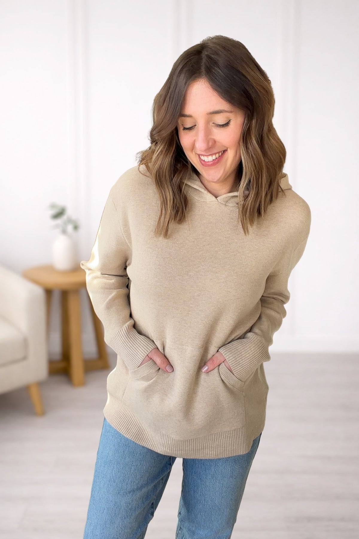 Front view of oatmeal oversized sweatshirt hoodie with relaxed fit and front pockets.