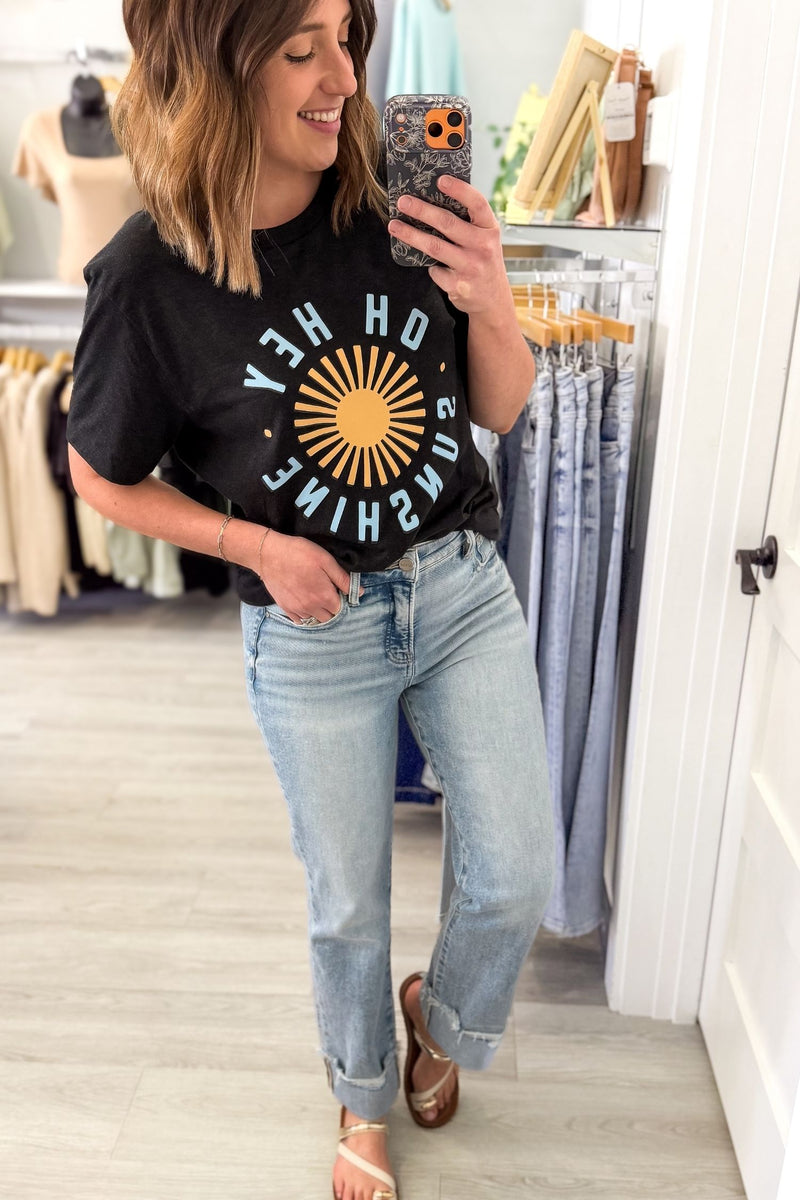 Woman wearing a black Oh Hey Sunshine graphic tee with yellow sun graphic and relaxed casual summer outfit