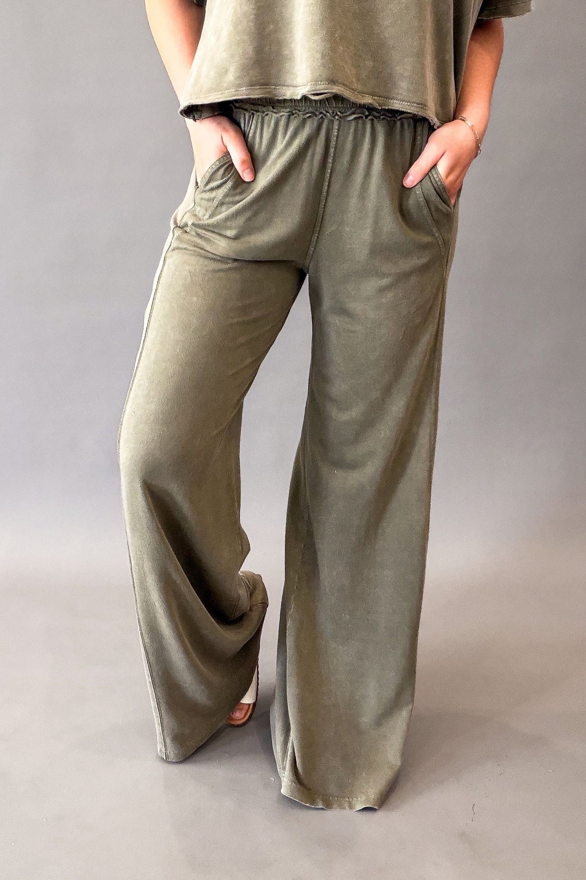woman wearing olive lounge pants with a 32.5" inseam and pockets