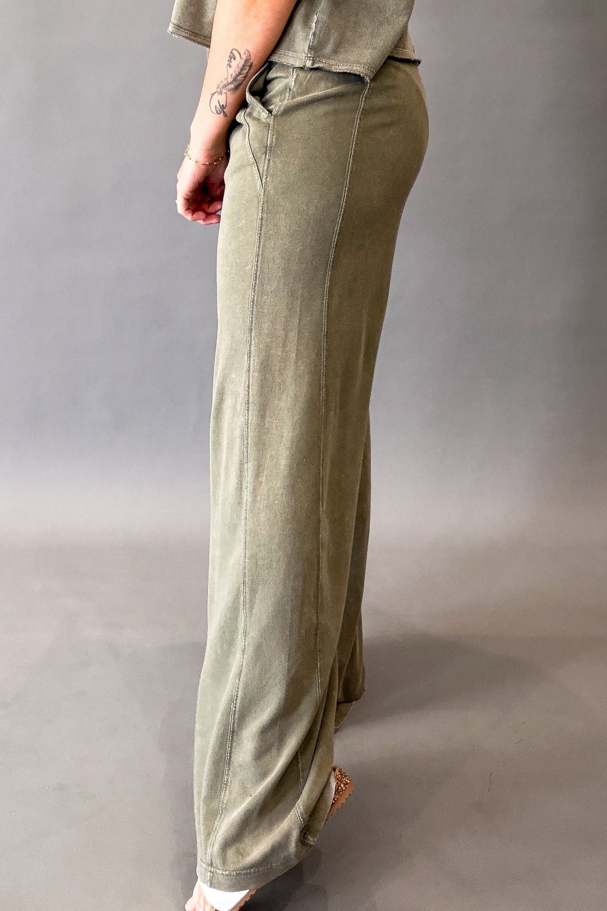 woman wearing olive lounge pants showing the length length