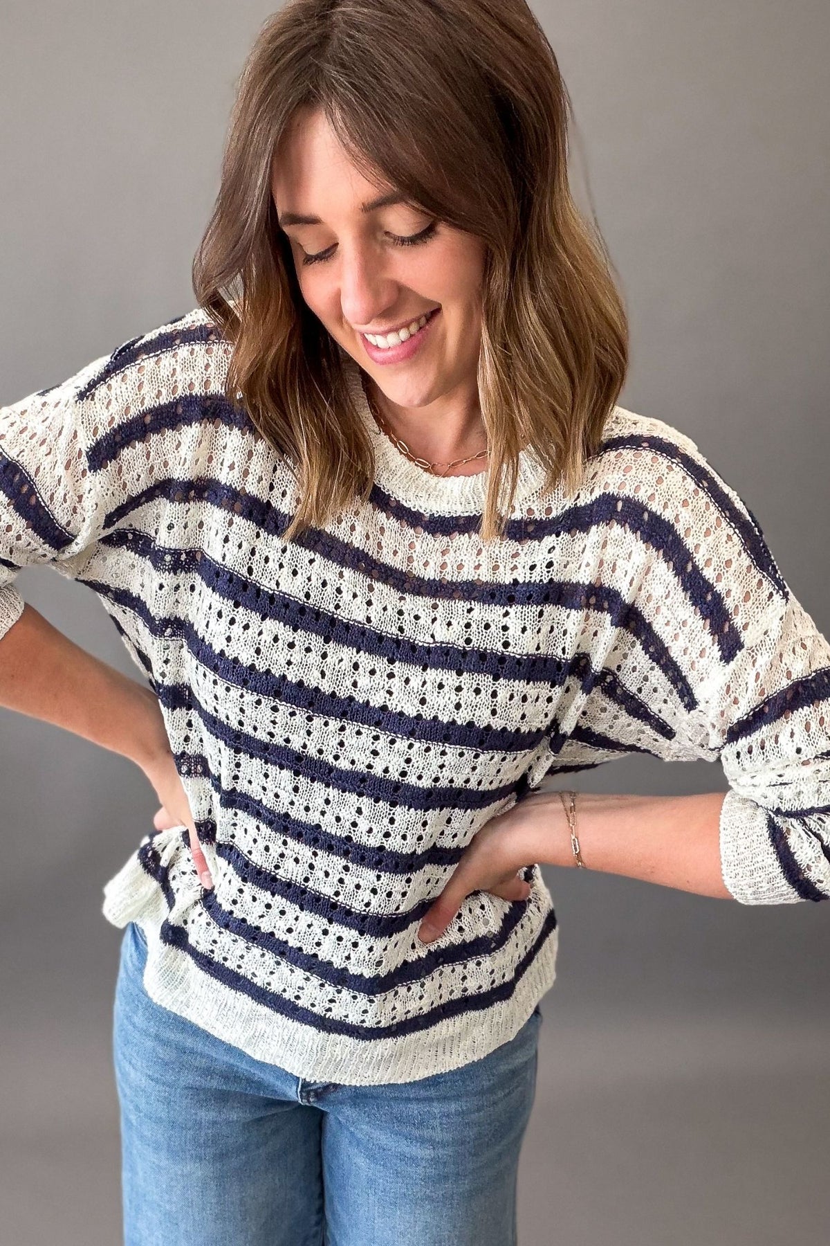 woman wearing a lightweight striped navy sweater