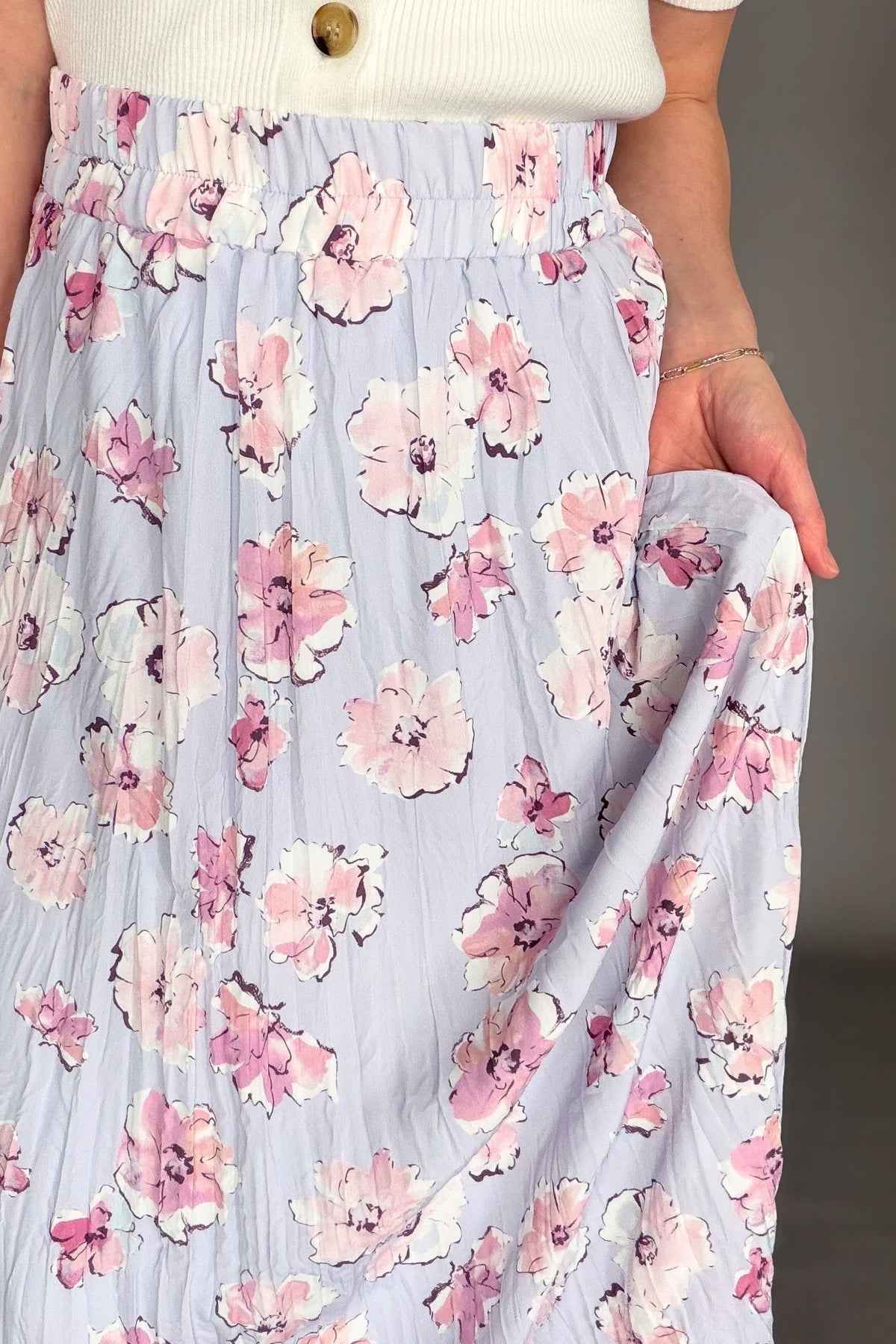Orchid floral maxi skirt with elastic waistband and soft floral print styled with ivory cardigan