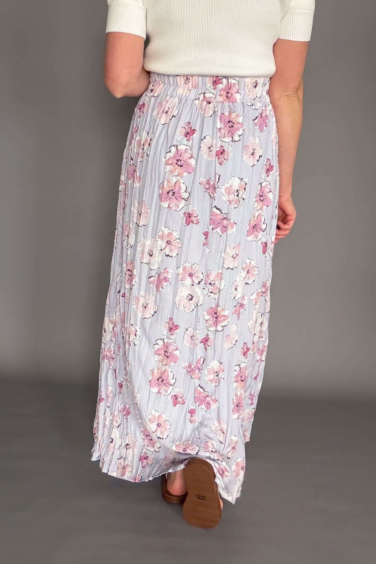 Orchid floral maxi skirt with elastic waistband and soft floral print styled with ivory cardigan showing the back.