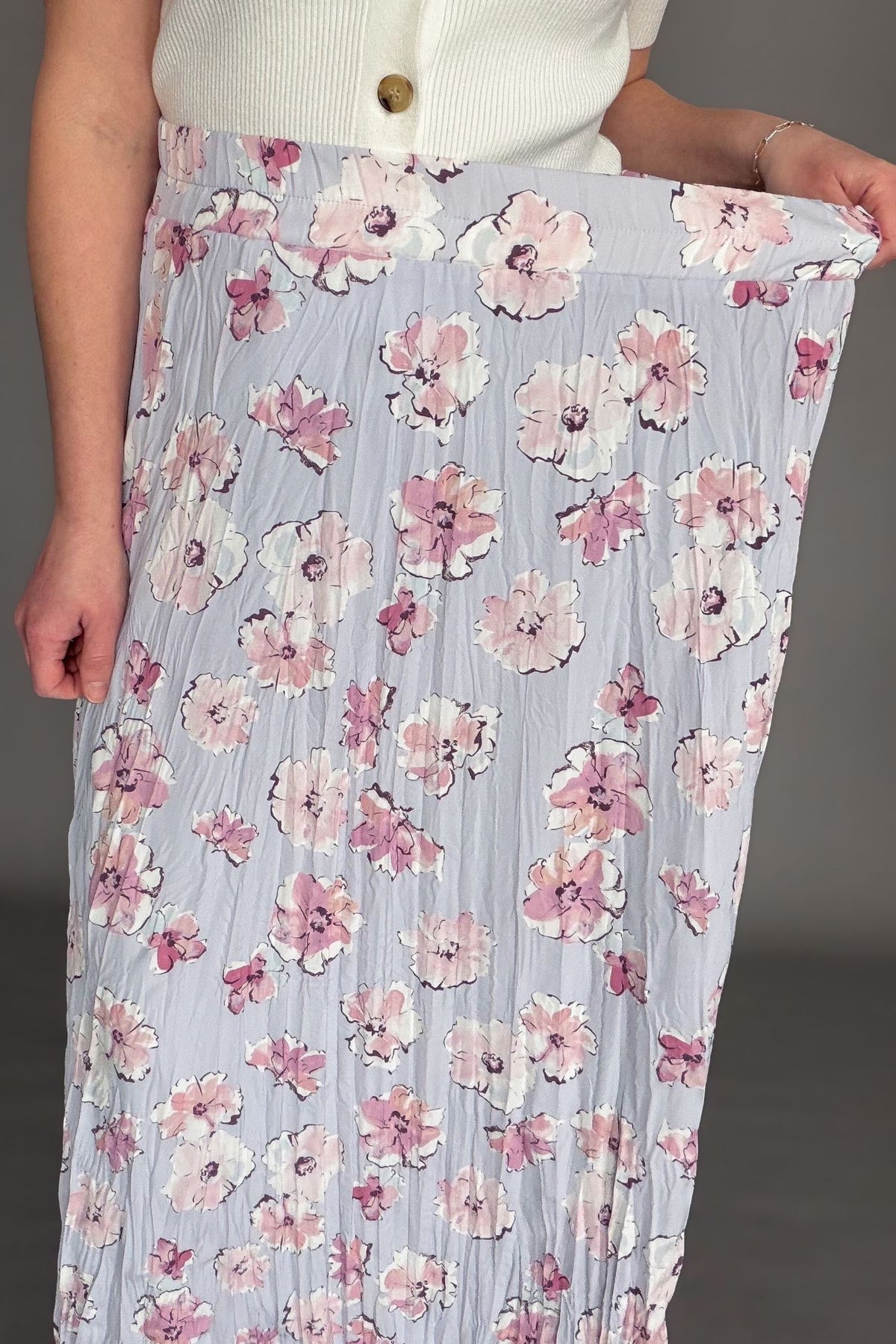 Orchid floral maxi skirt with elastic waistband and soft floral print styled with ivory cardigan