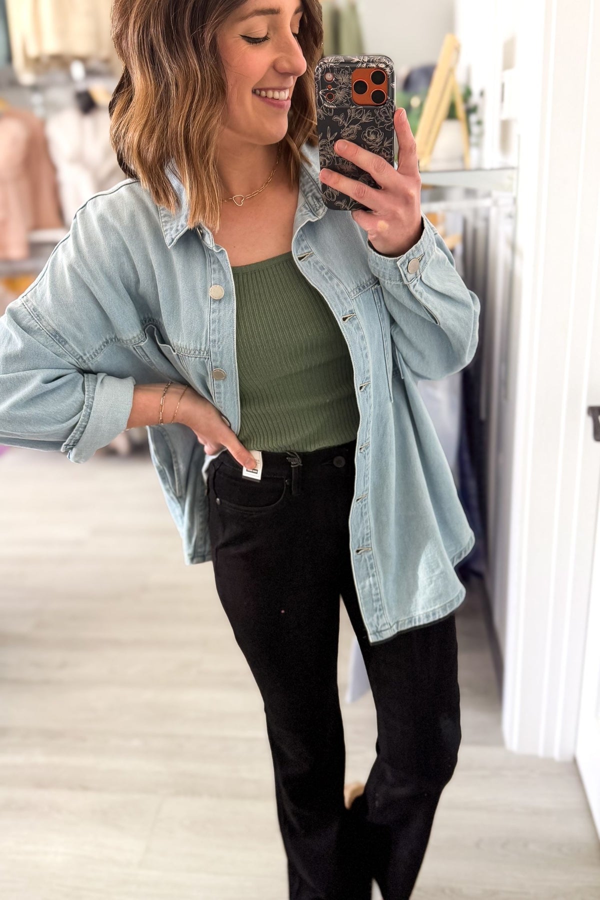 Oversized light wash denim jacket styled with black jeans