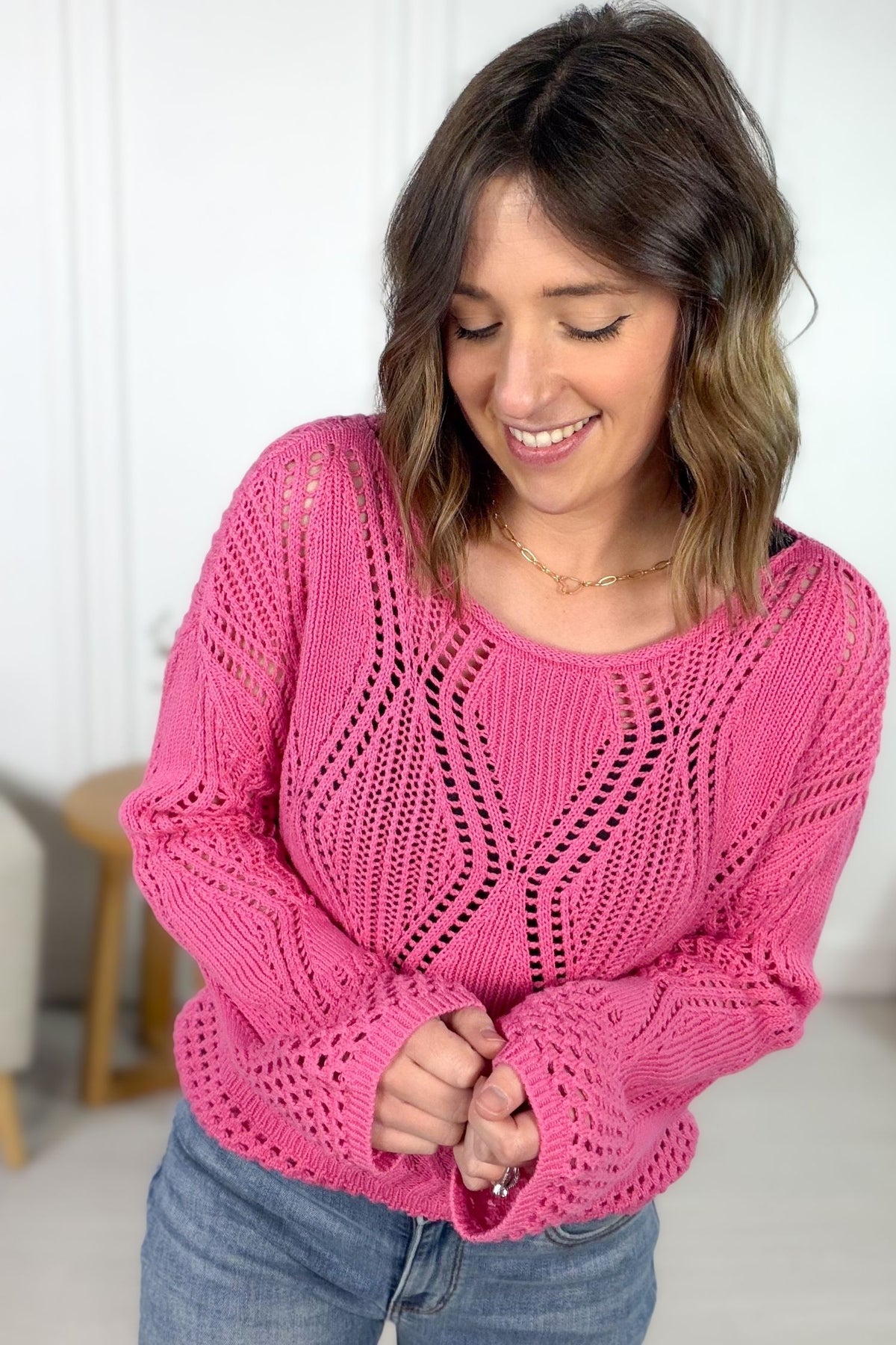 Pink crochet boatneck sweater styled with denim