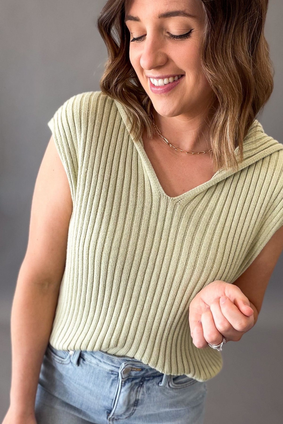 woman wearing a green ribbed sweater top