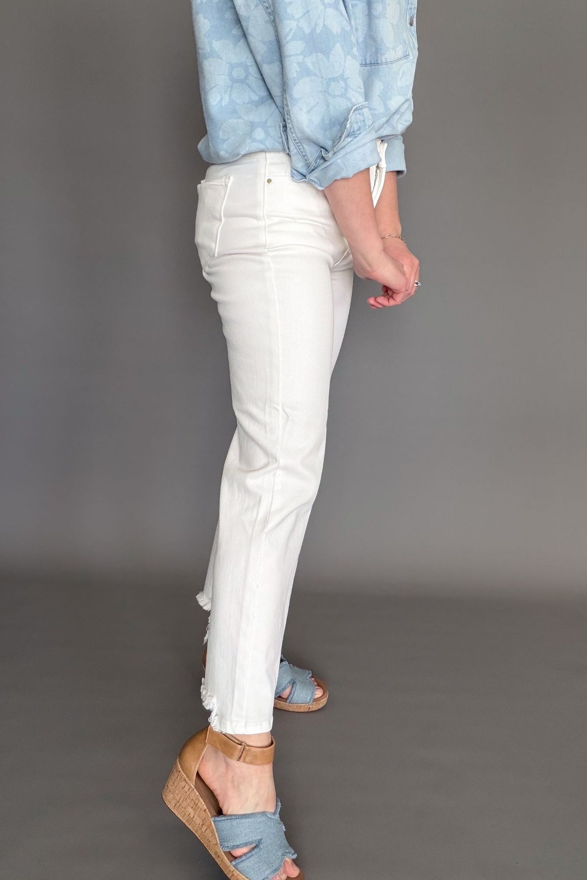 Risen high rise tummy control white straight crop jeans styled with sandals showing the side details.