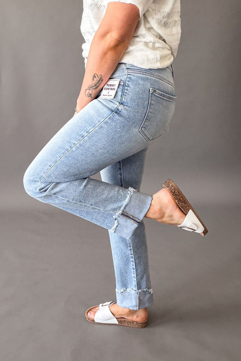 Woman wearing Risen high rise tummy control straight leg jeans with cuffed hem, light wash cropped denim for women showing the cuff at the bottom