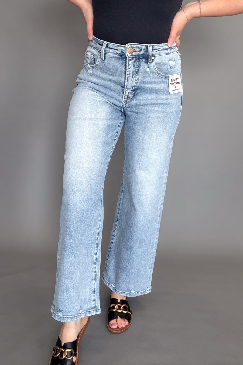 woman wearing light wash high rise tummy control wide leg jeans
