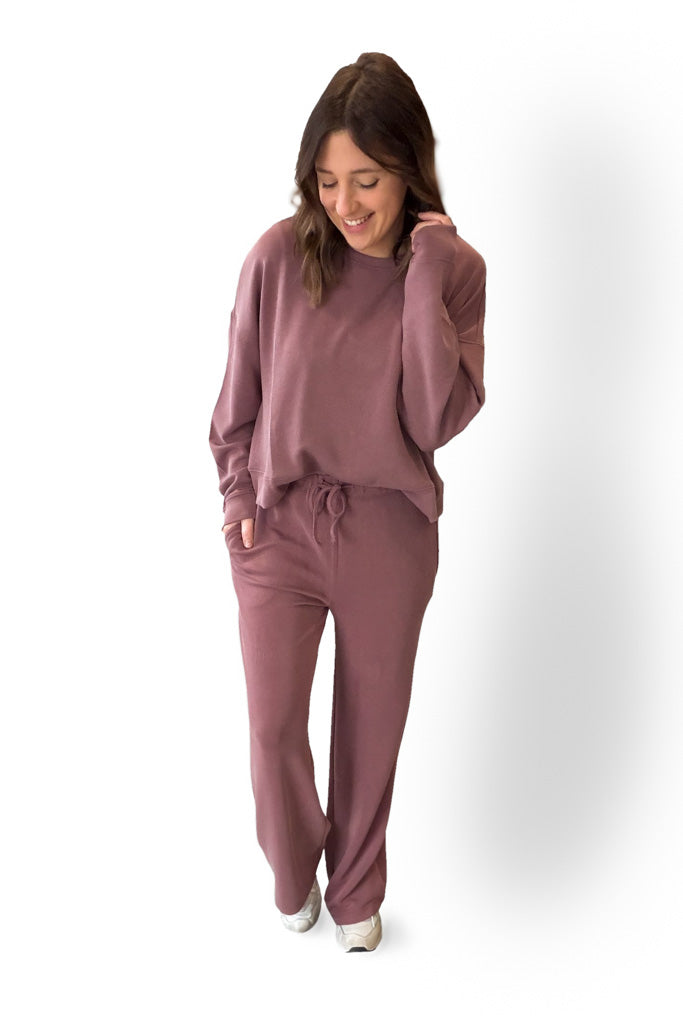 Woman wearing a Rose lounge set on a white background