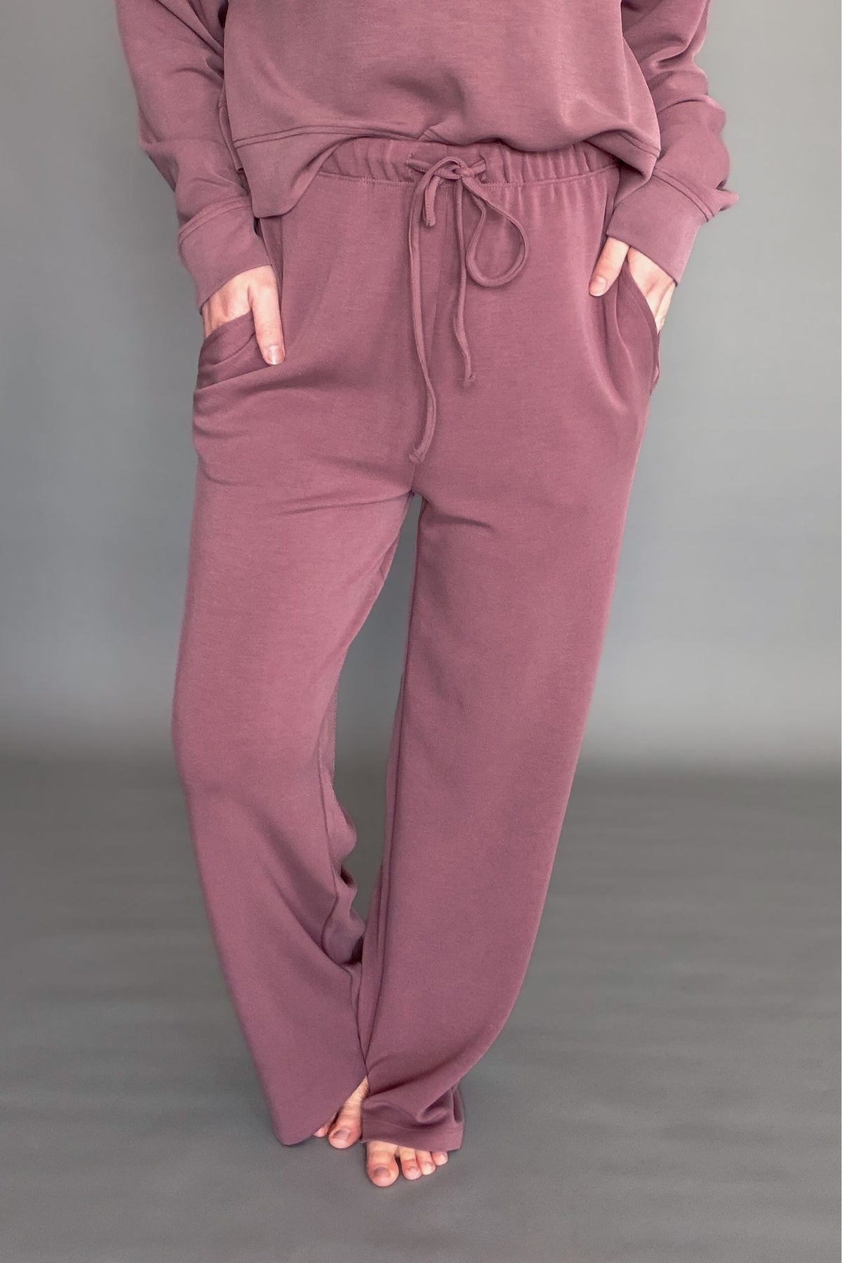 Women's rose wide leg lounge bottoms with drawstring pants on a gray background