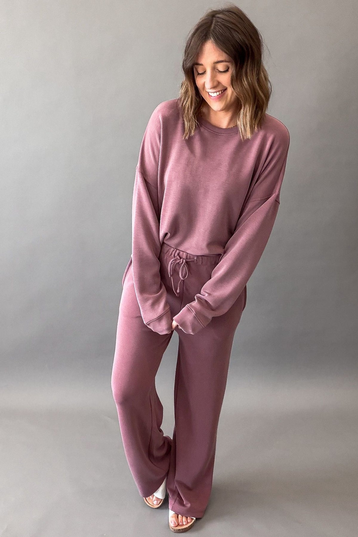 woman wearing a rose pant and sweatshirt set