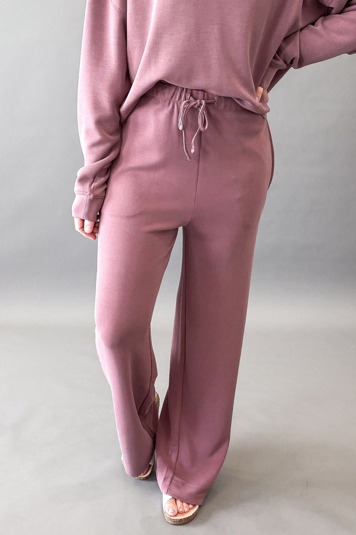 woman wearing a rose pant and sweatshirt set