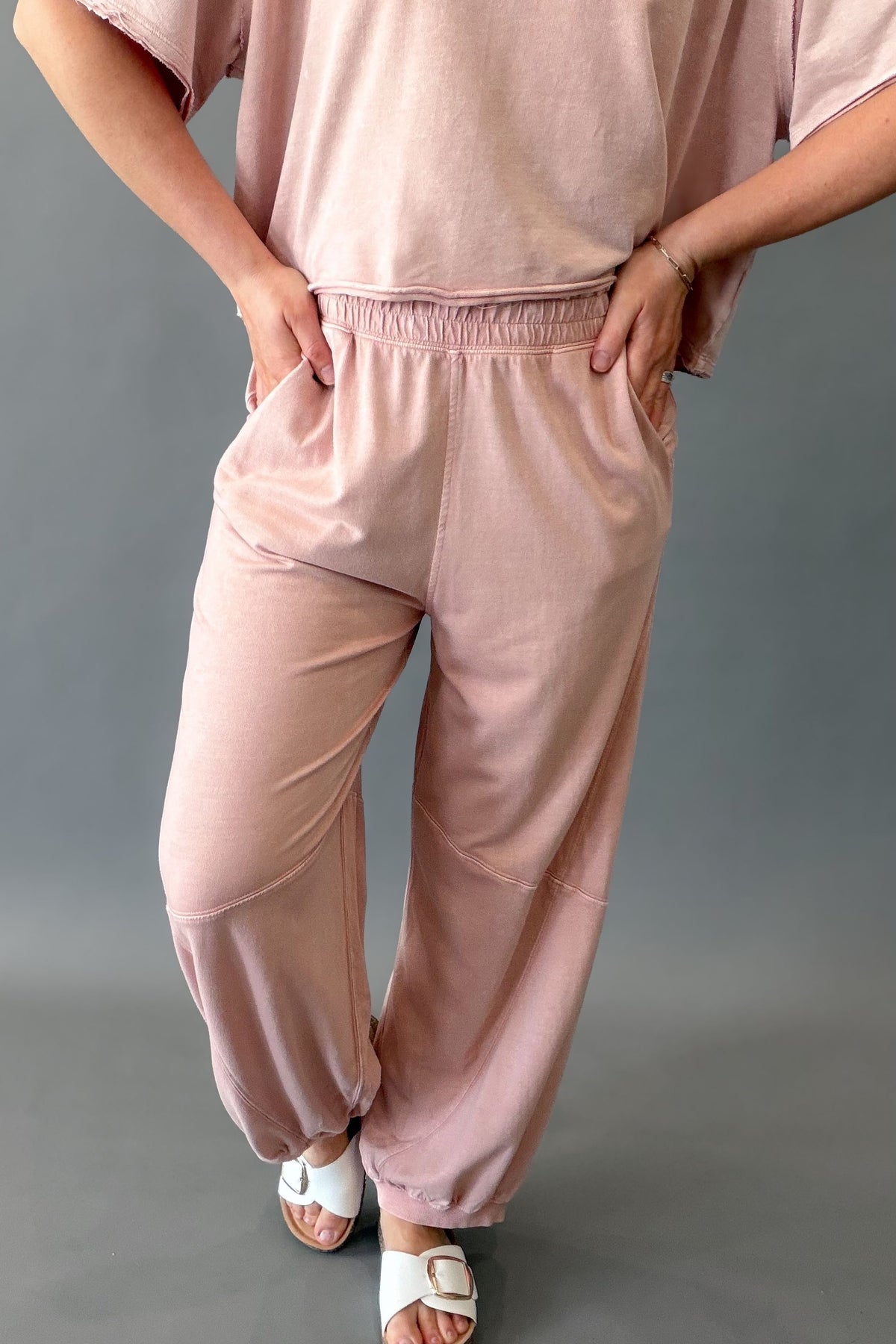 woman wearing a pink terry jogger pant with pockets