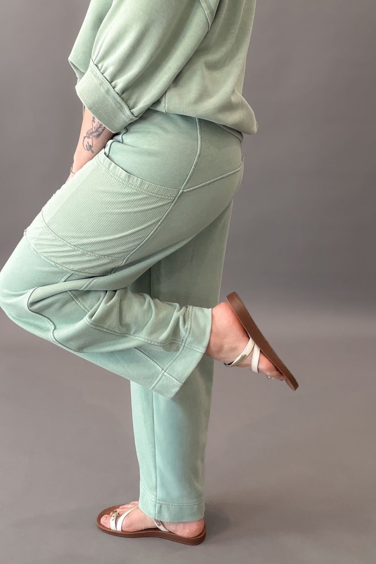 woman wearing sage pocket pants with matching top and sandals