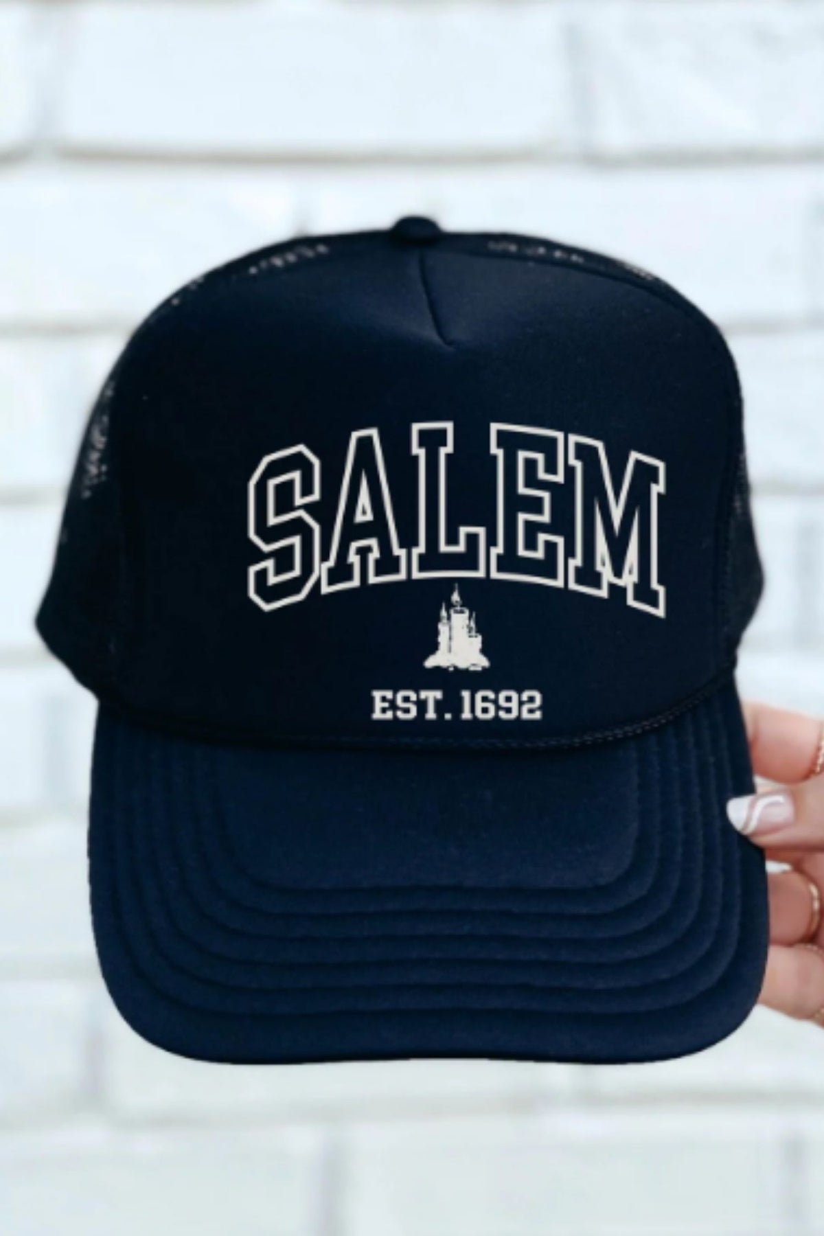 Black cap with 'Salem Est. 1692' text on a white background