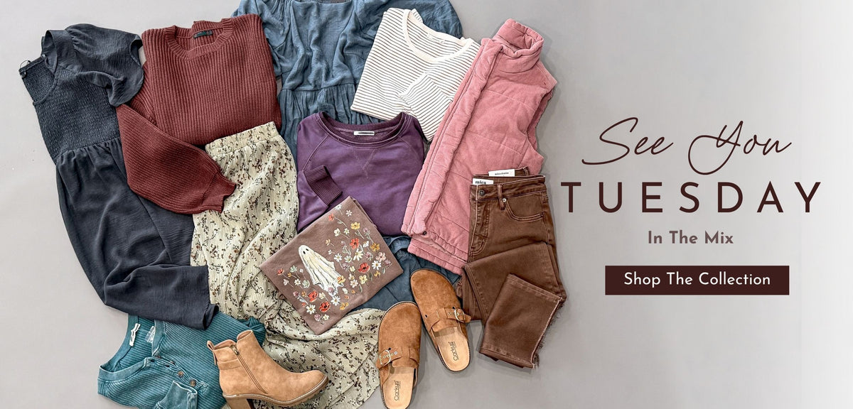 A styled flat lay of multiple clothing items and accessories arranged on a light gray background, with decorative text reading 'See You TUESDAY In The Mix' and 'Shop The Collection.' The products include several tops, pants, a clutch, and shoes in muted earthy and pastel tones.