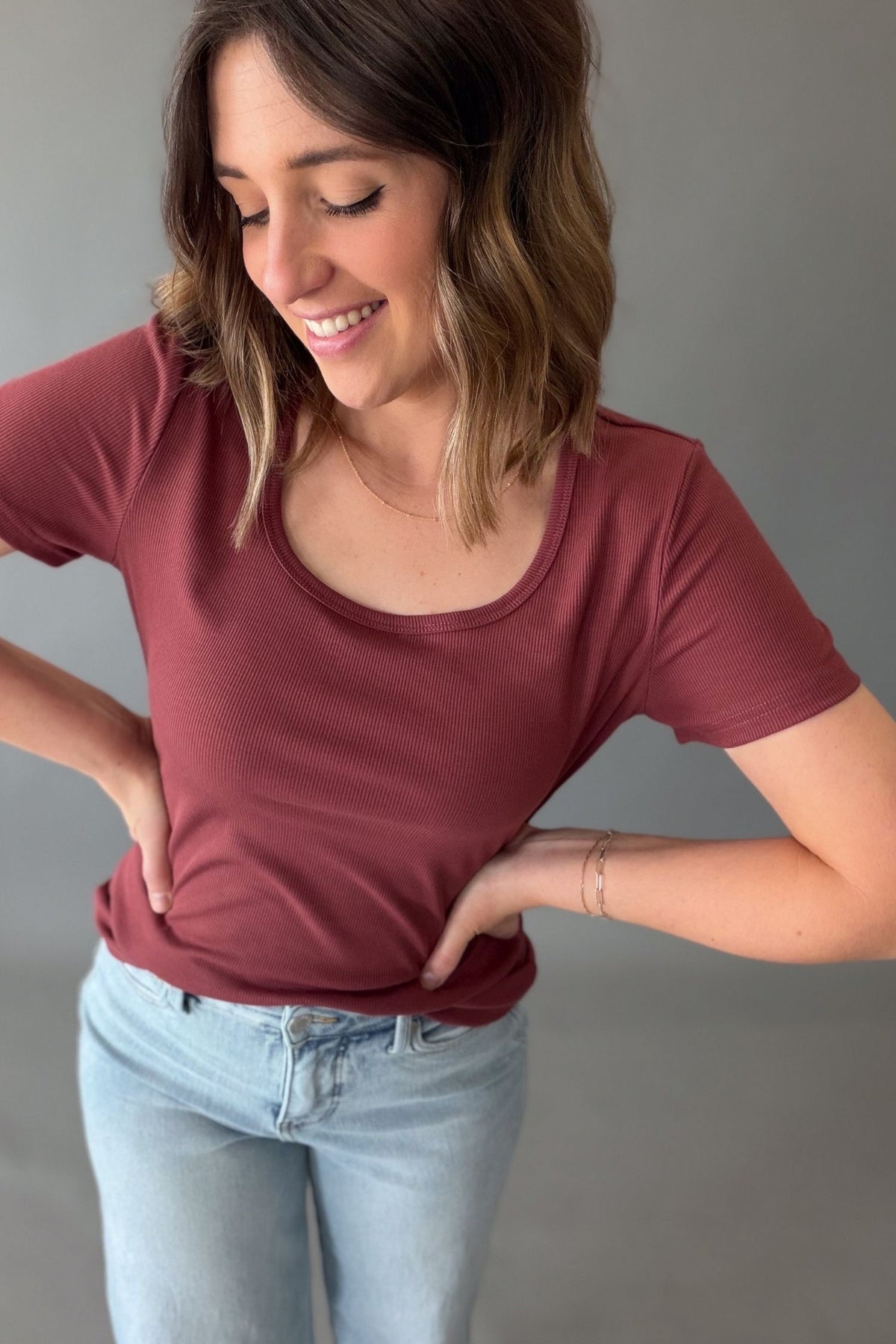 Woman wearing a ribbed textured scoop neck basic tee