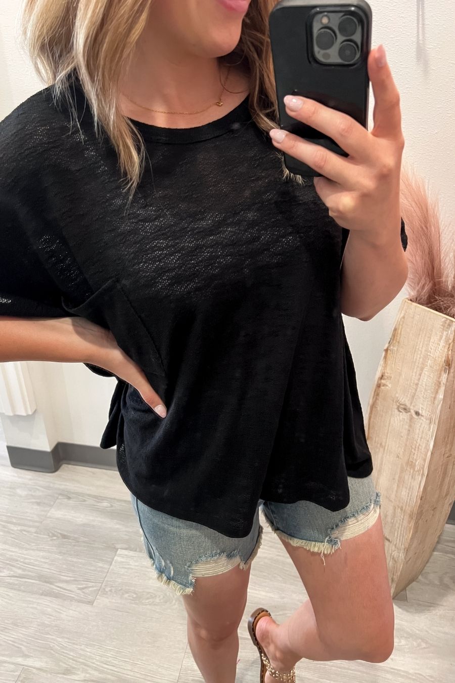 Close-up of black textured slub knit fabric on short sleeve top
