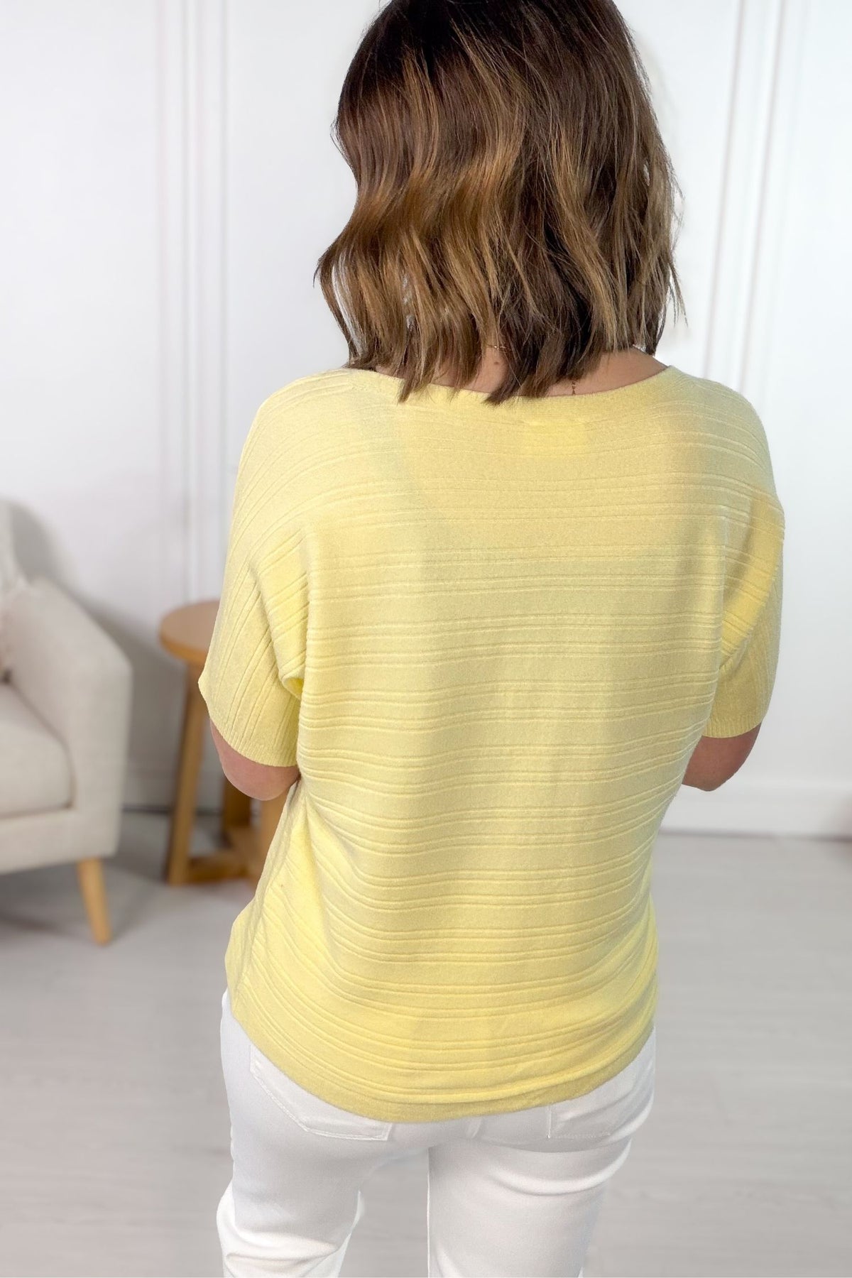 Soft yellow ribbed short sleeve tee styled with white denim jeans showing the back details