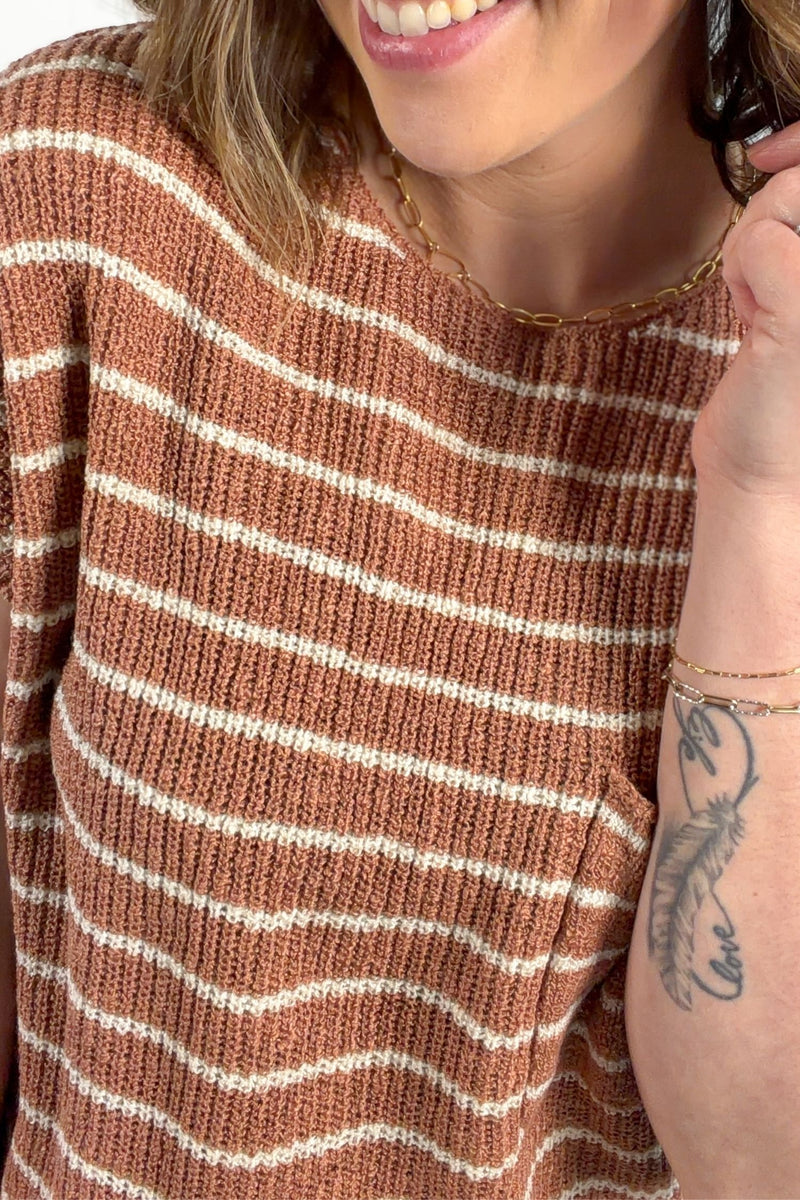 Terracotta striped knit short sleeve top styled with denim jeans showing knit details