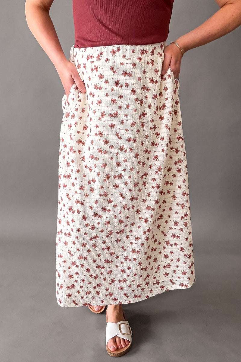 woman wearing  muted floral midi skirt with pockets