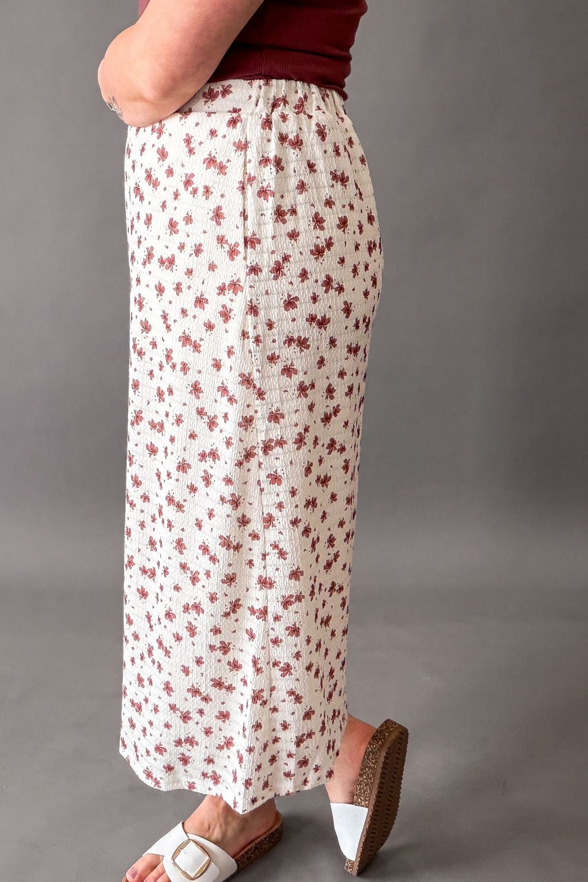 woman wearing a textured midi skirt showing the side details