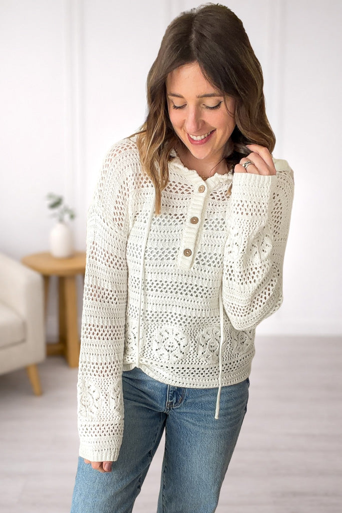 Front view of premium white crochet v-neck hoodie with open knit texture and relaxed fit.