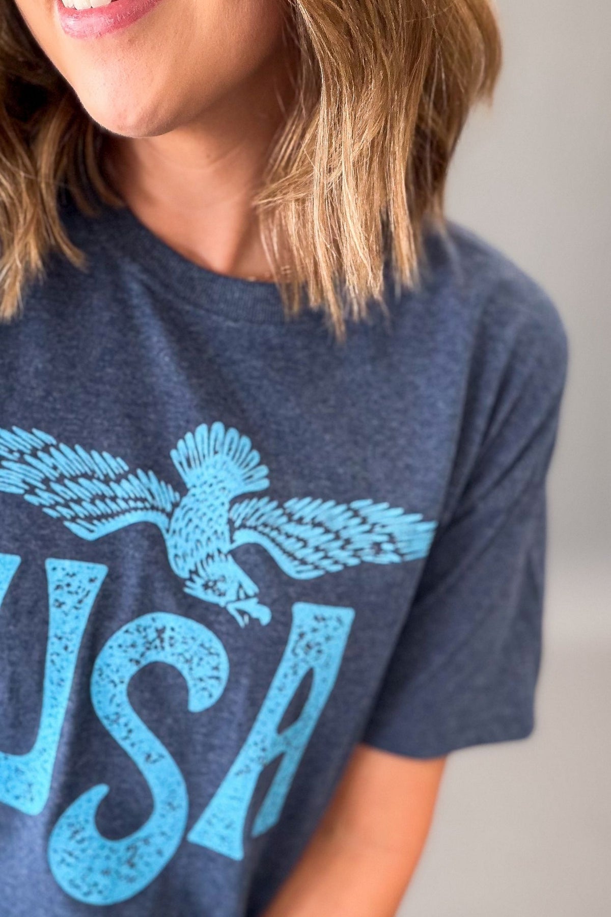 close up of the navy and light blue screen printed vintage usa tee
