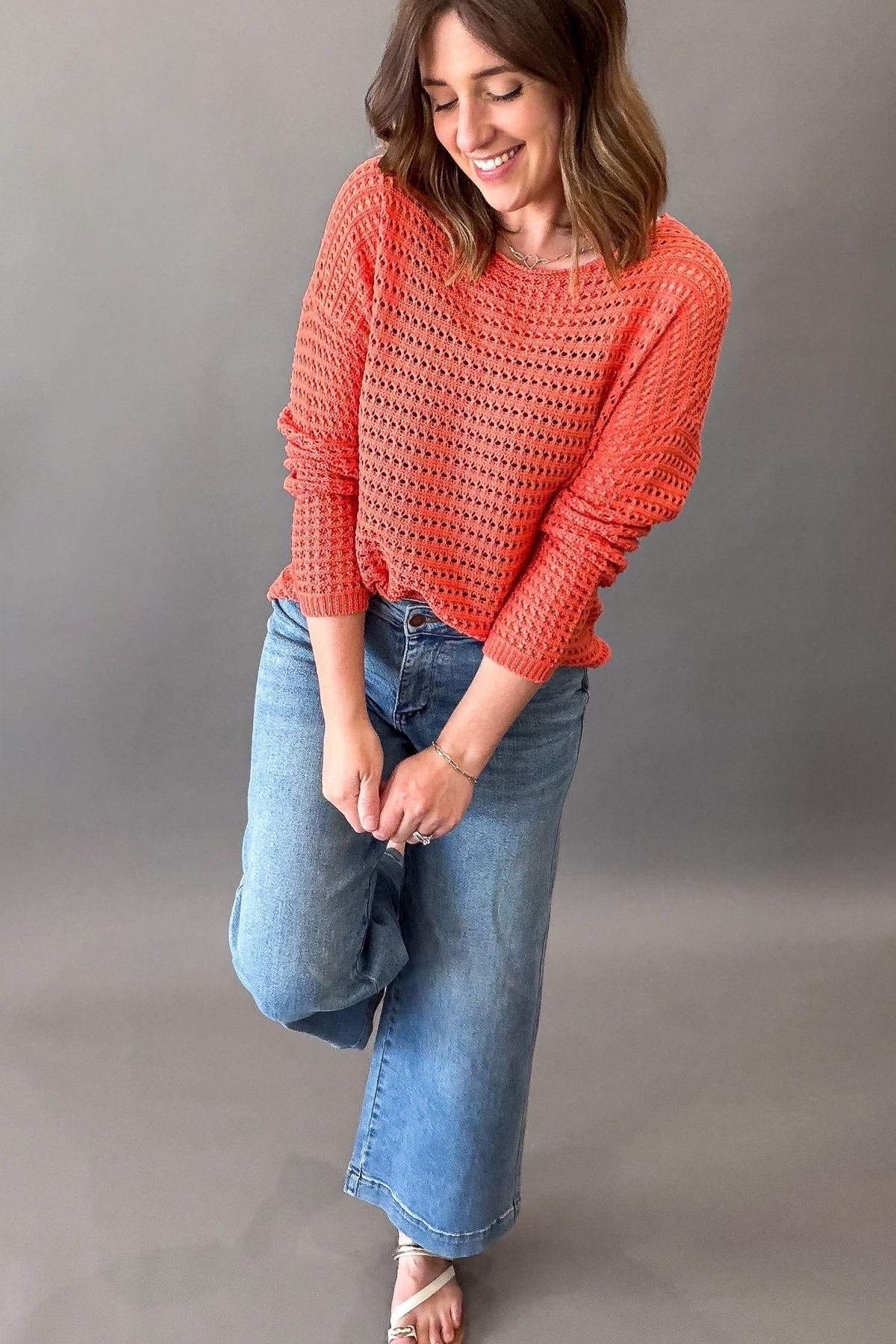 woman wearing a crochet knit sweater