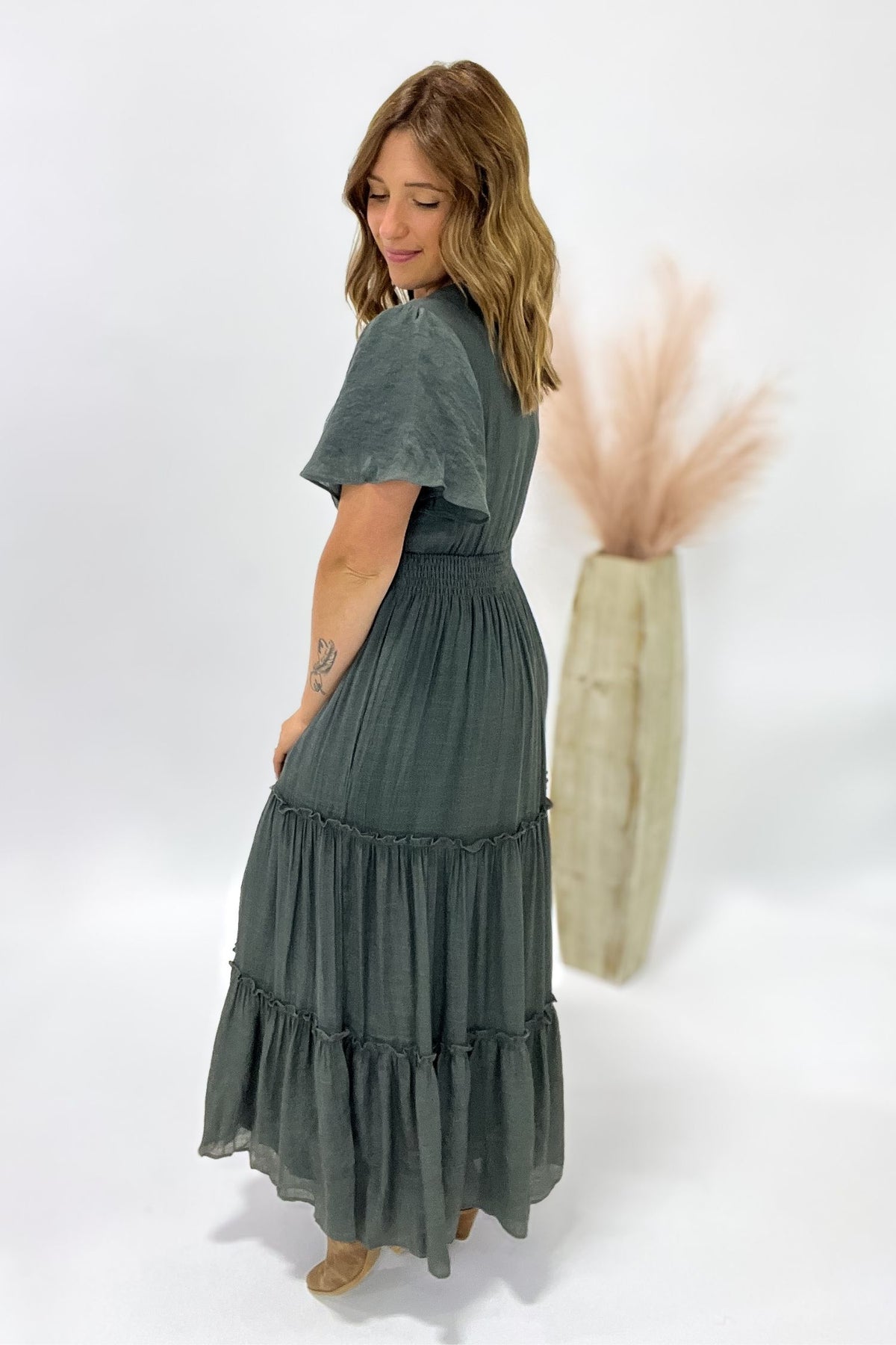 Woman wearing a green dress with a white background