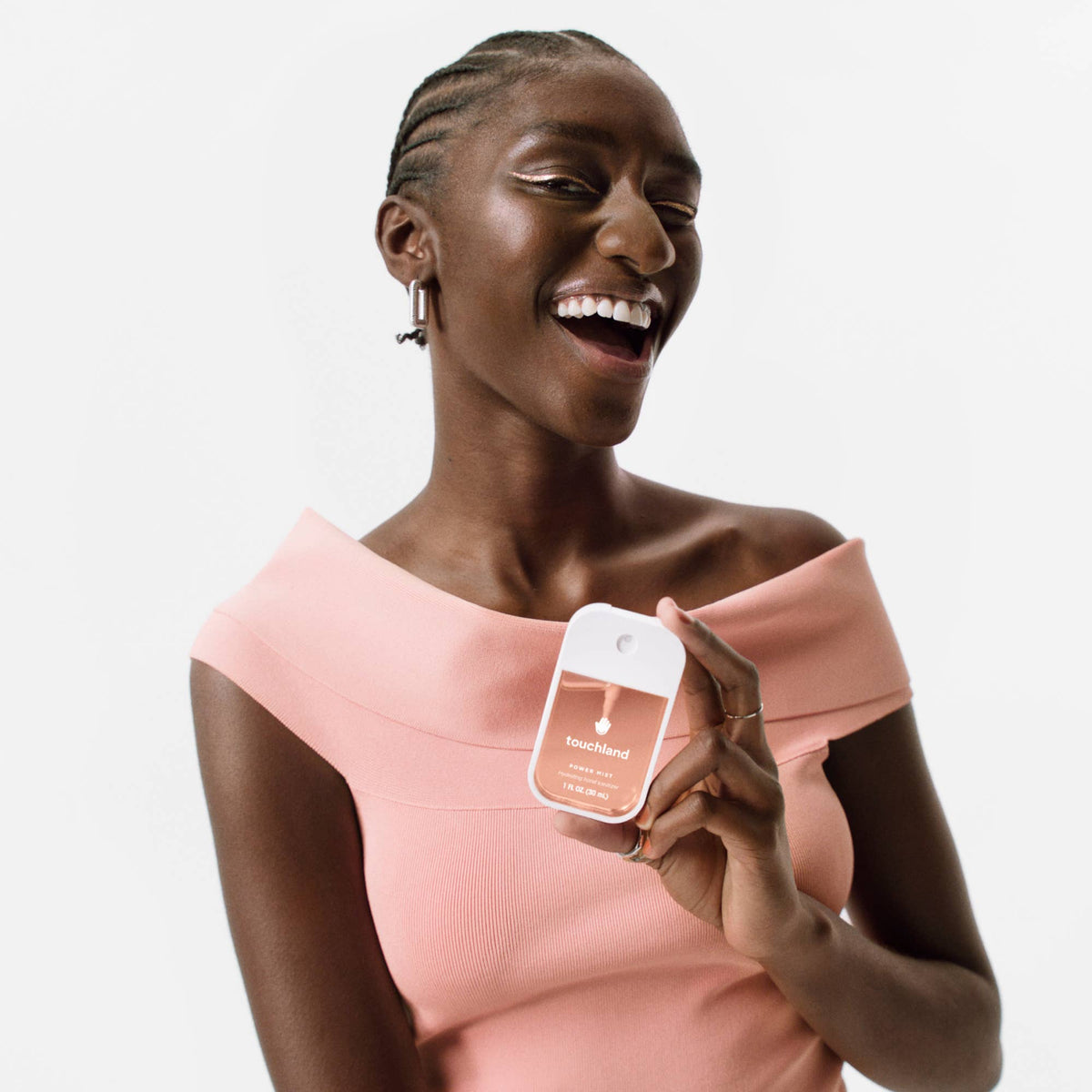 Woman holding a product packaging with a neutral background