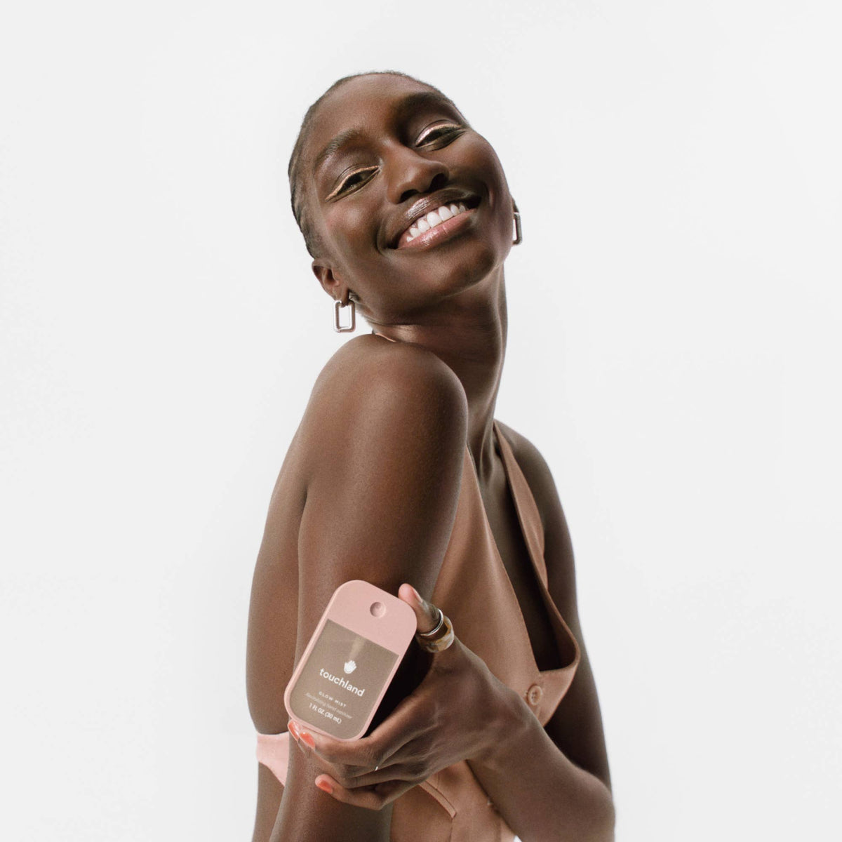 Woman holding a pink product with a white background