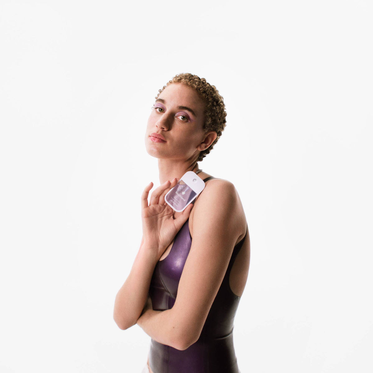 Woman holding a white device against a white background